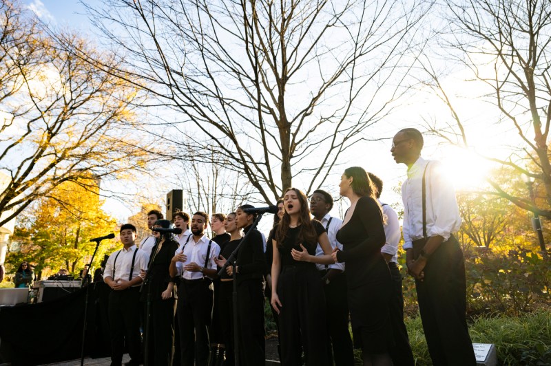 A group of people singing outside. 