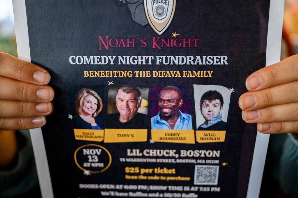 A person holding up an advertisement for the Comedy Night Fundraiser.