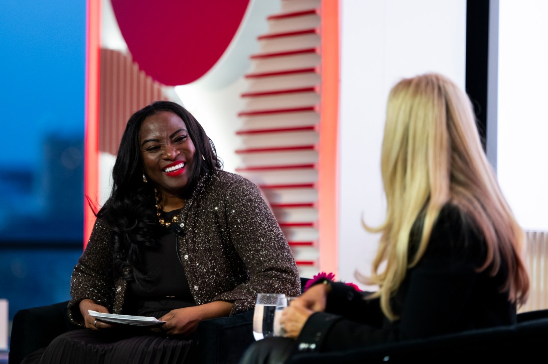 Two people smiling together at the Women Who Empower event.