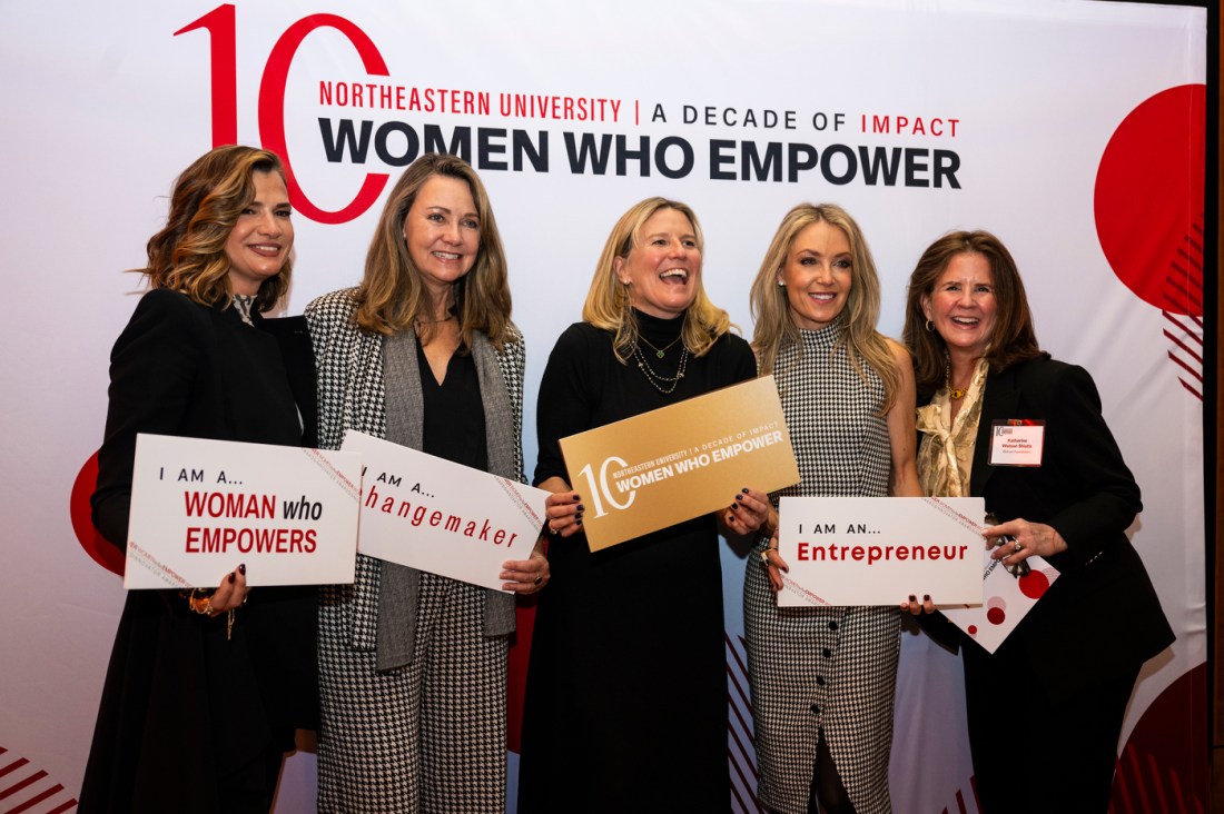 Five people posing at the Women Who Empower event.