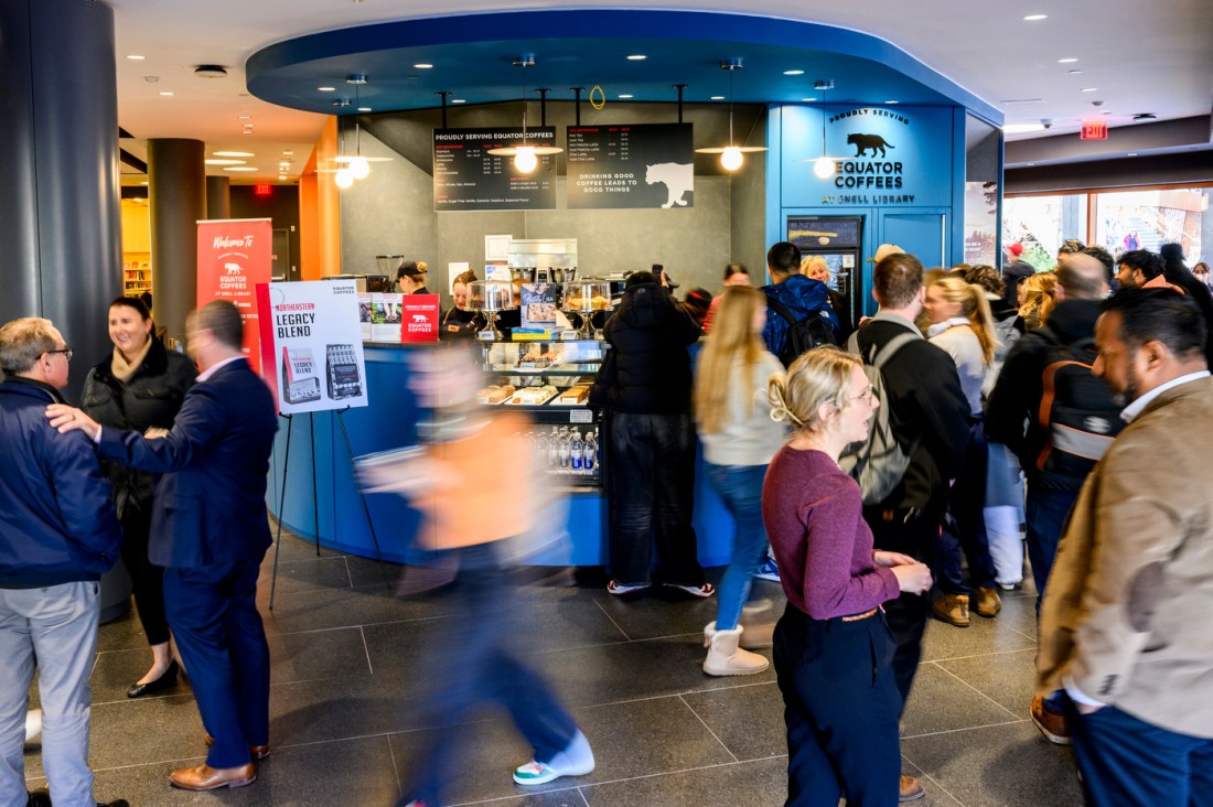 A timelapse photo of people milling about the new Equator Coffees in Snell Library.