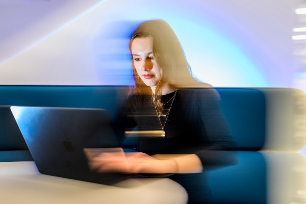 Ava Knight working on a laptop.