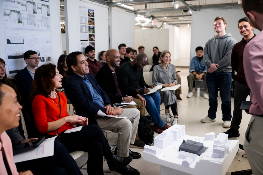 Students presenting architectural designs to members of the church.