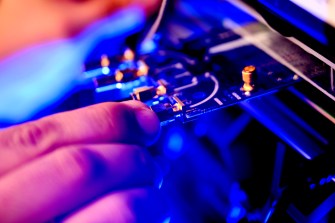 A person's hands on a switchboard