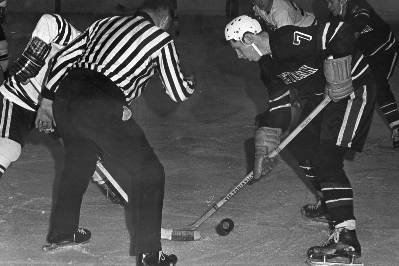 David Poile in a puck drop while playing for Northeastern.