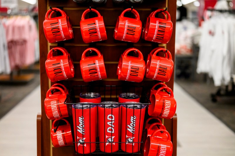 Red Northeastern branded mugs that say Mom, Dad, Alumni, Grandparent. 