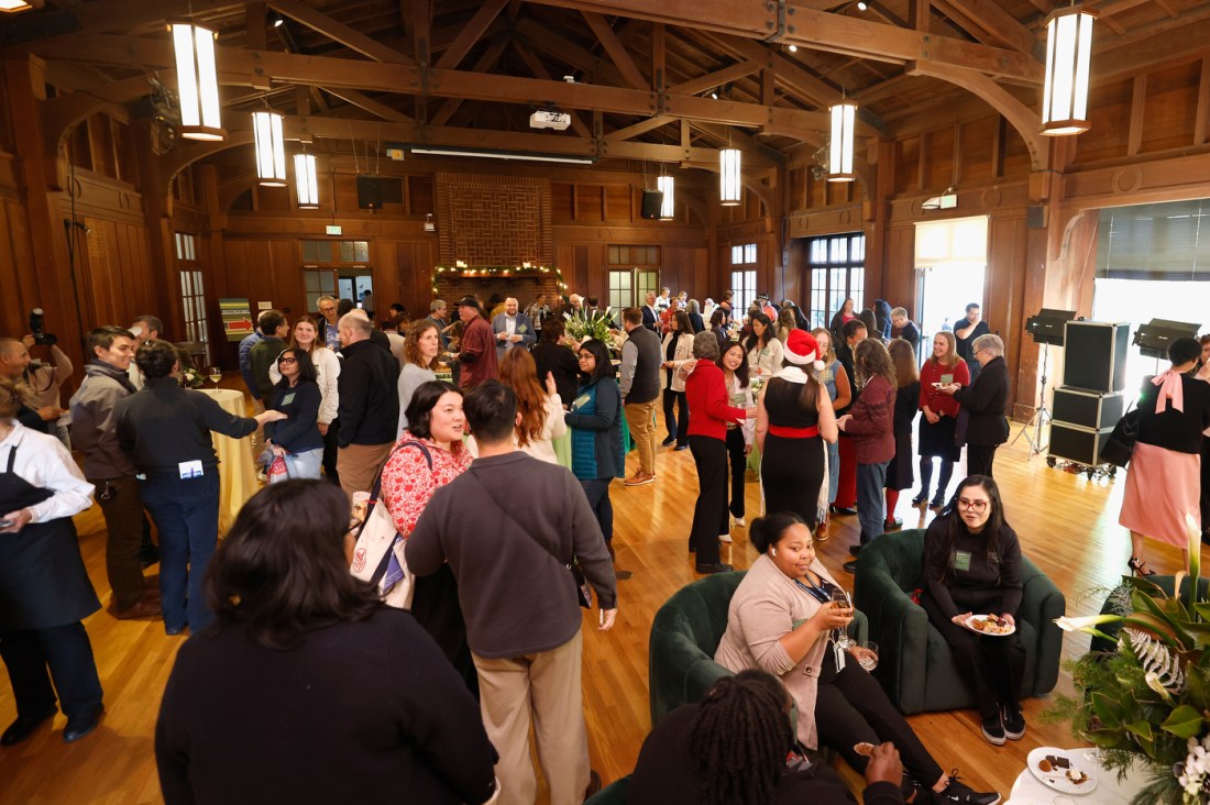 People milling about an event space in Oakland for the Holiday Social.