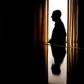 Silhouette of a person at a desk.