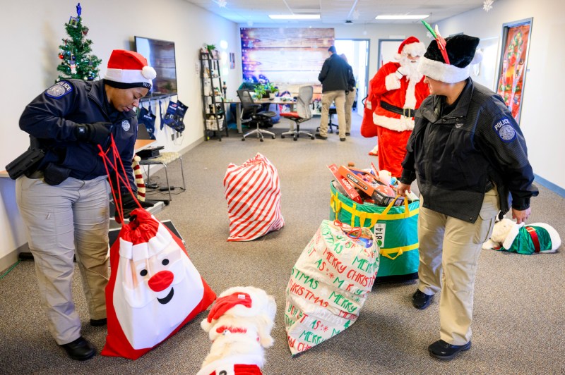 NUPD officers helping carry bags of toys.