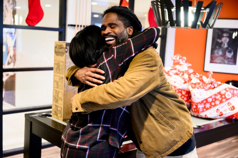 Two Northeastern staff members hugging.