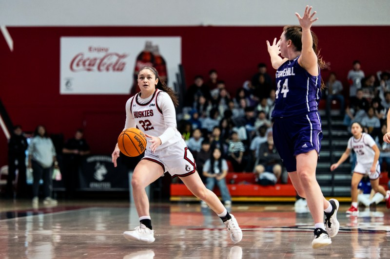 A womens basketball player dribbles down the court.