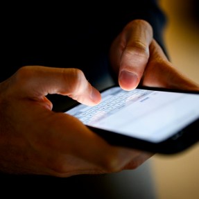 A person typing on their smartphone.