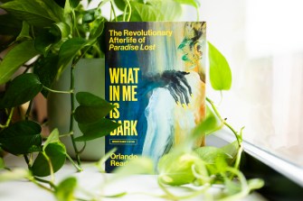 The cover of a book by Oralndo Reade titled "What In Me Is Dark".