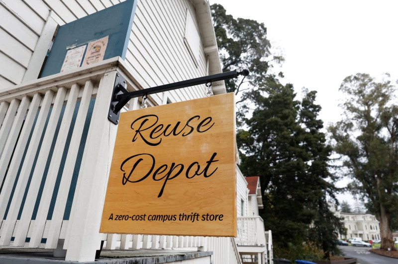 A wooden sign on the outside of a building that says 'Reuse Depot'.