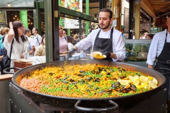 A food stall worker making Spanish paella.