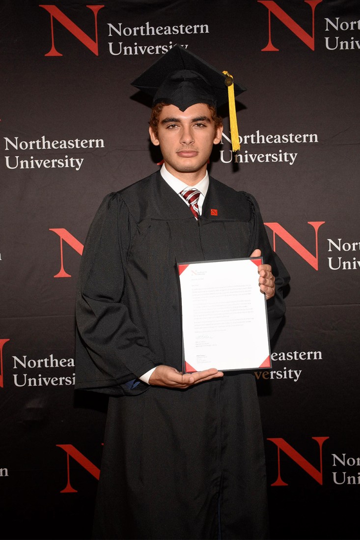 Cesar Perez holding his diploma.