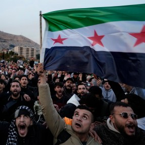 Syrian citizens waving the revolutionary flag.