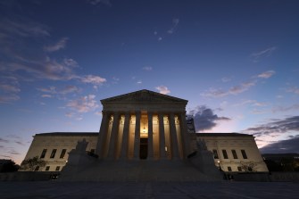 The U.S. Supreme Court building photographed at dusk.