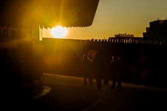 Rays of sun illuminate the Interdisciplinary Science and Engineering Complex on Northeastern’s Boston campus as members of the Northeastern community walk outside of the building.