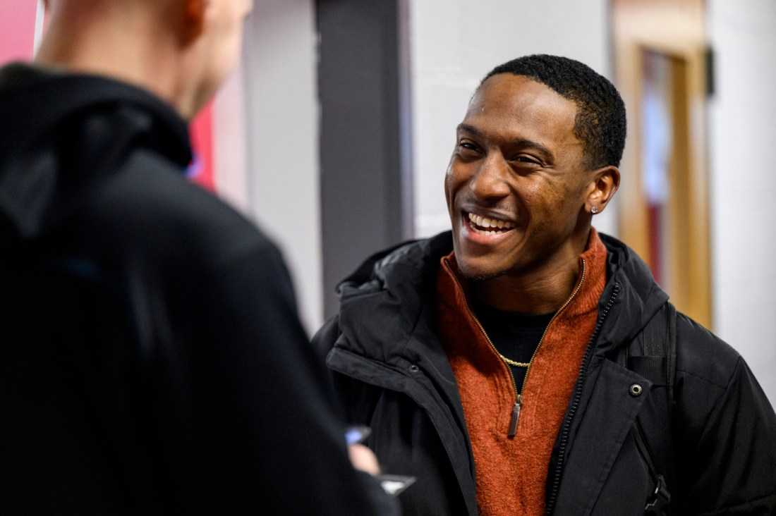 Two people talking at the athletics co-op fair.