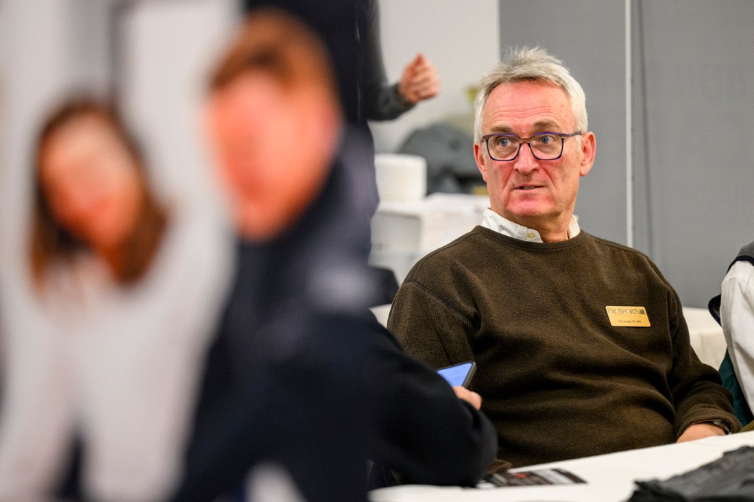 A person sitting at the athletics co-op fair.