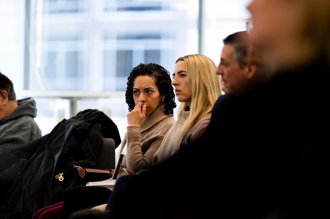 Audience members listening intently.