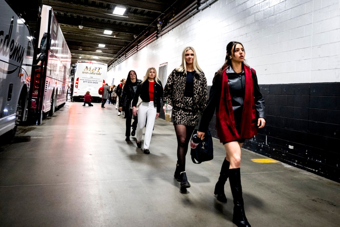 Northeastern womens hockey players walk into the arena.