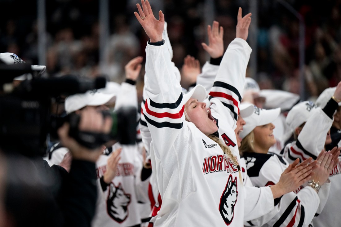 Women's hockey players cheering