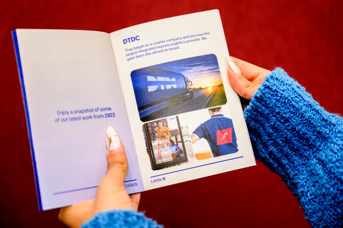 Yana Puri's hands holding a 'Landor' pamphlet to show an interior spread.