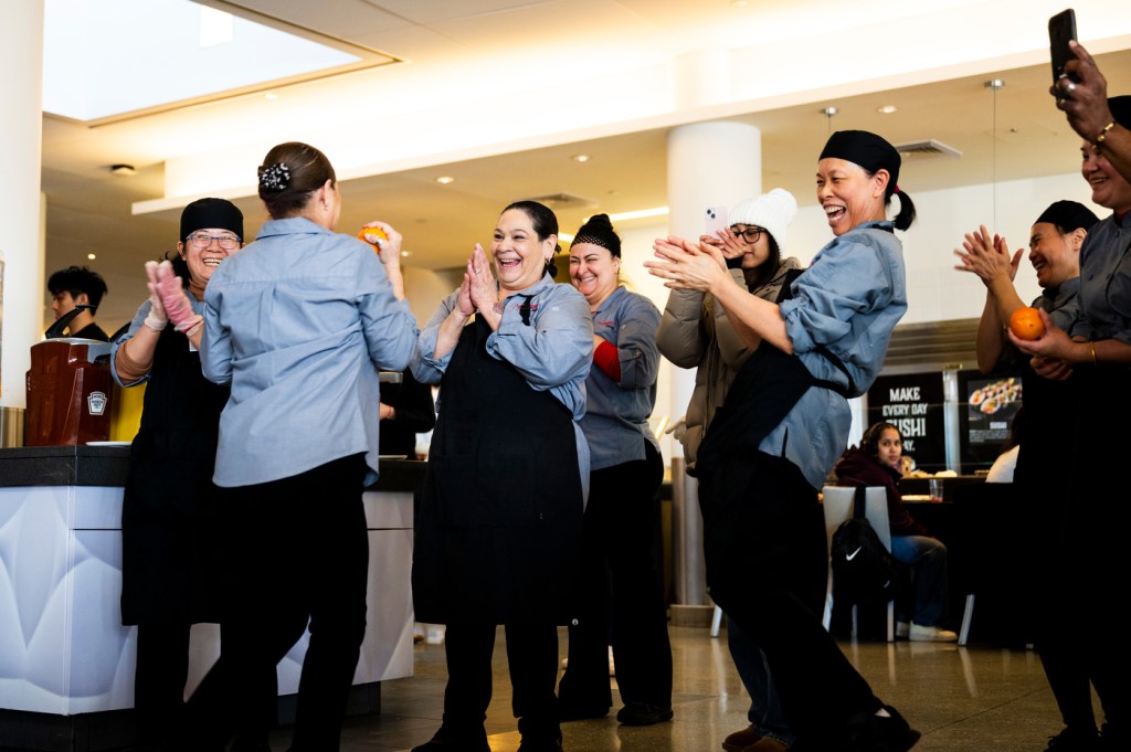 People gather in a dining hall to celebrate a cultural event with food and festivities.