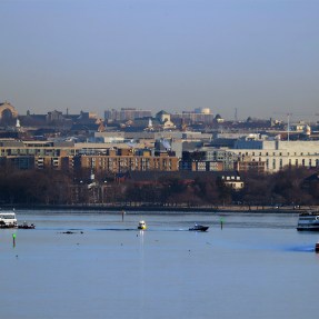 The view of a river in DC from a bridge where search and rescue crews are in boats on the water.