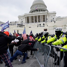 Police men barricading rioters outside of the capitol in Washington DC.