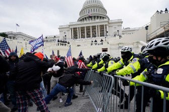 Police men barricading rioters outside of the capitol in Washington DC.