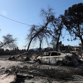 A charred car and house in Los Angeles.