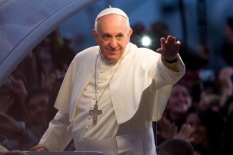 Pope Francis holding a hand out.