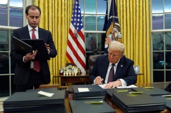 Trump signing a pardon.