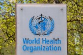 A sign reading &#039;World Health Organization&#039; with the logo on top all in blue.