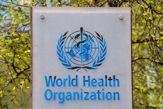 A sign reading 'World Health Organization' with the logo on top all in blue.