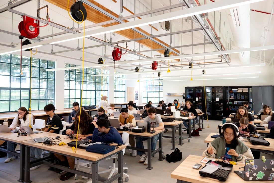 Students and instructors work together on various activities in a makerspace.