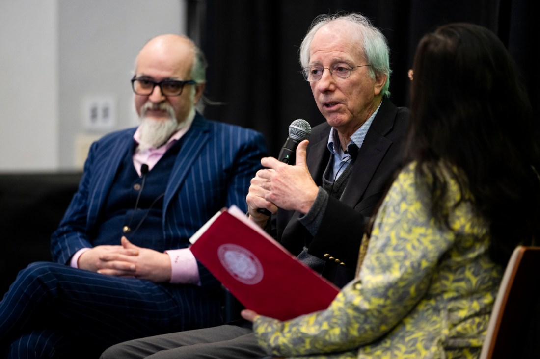 Dennis Ross speaking into a microphone with Ghaith al-Omari sitting nexto him on stage at the fireside chat.