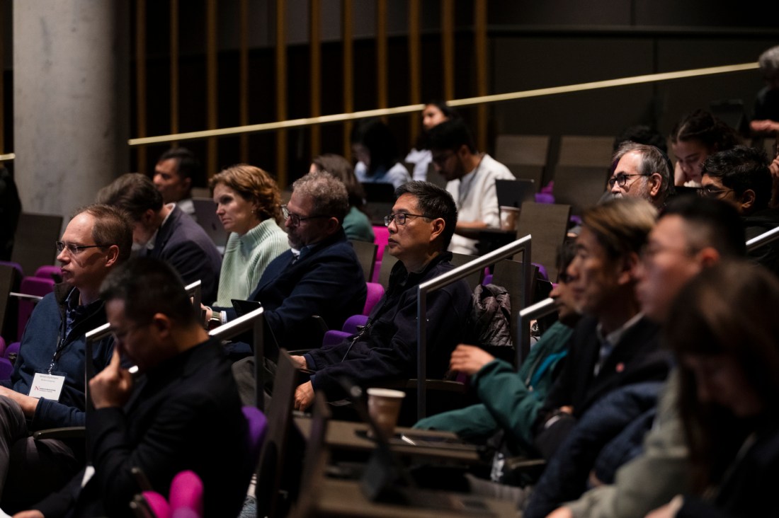 Audience members listening in an auditorium at the global summit. 