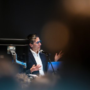 Alison Bechdel speaking on stage at the Hanson Lecture.
