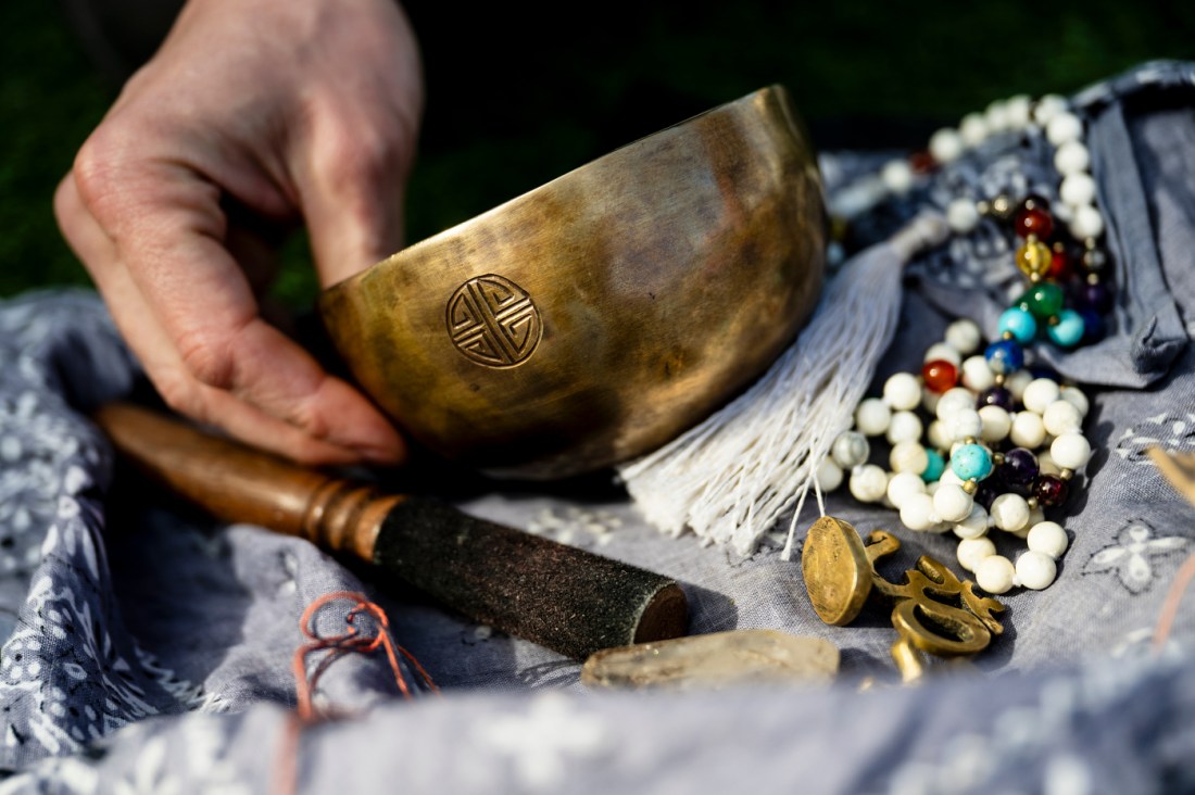 Evan Kenny's hands holding a prayer bowl.
