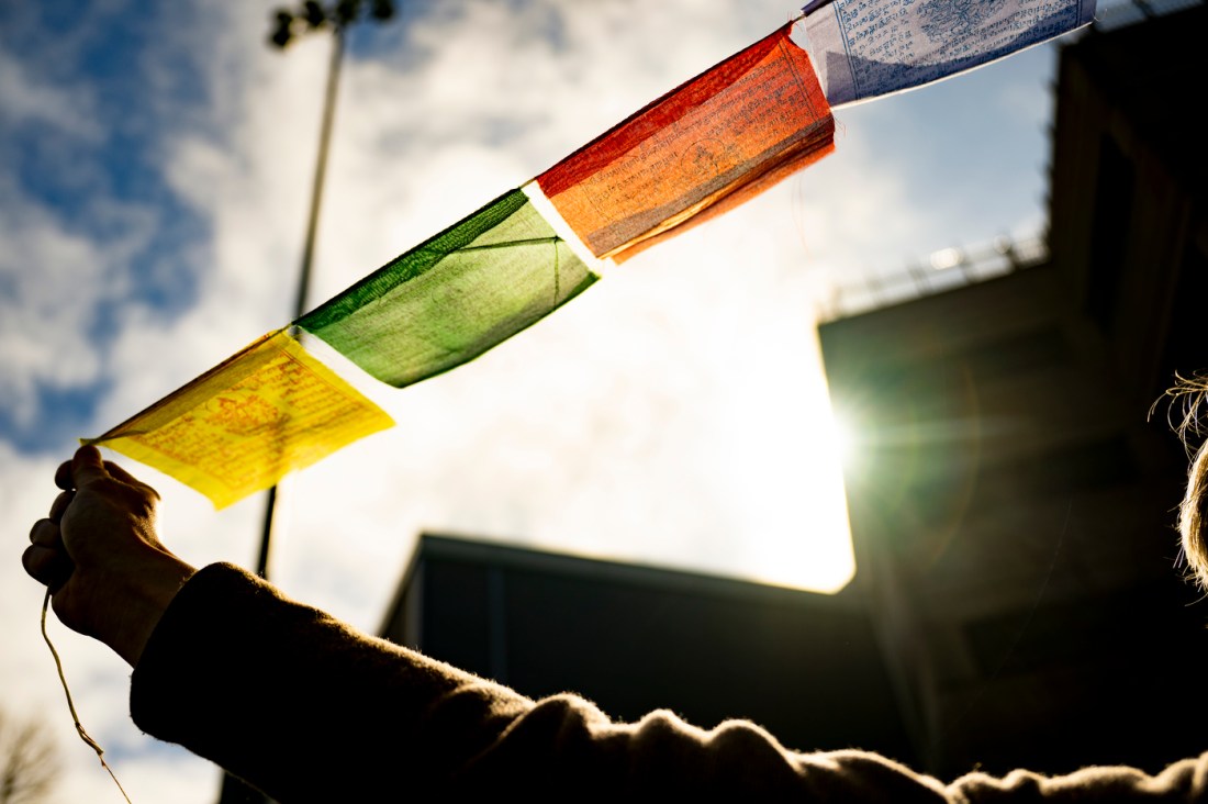 Evan Kenny holding multicolored flags on a string.