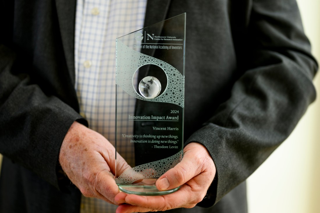 Vincent Harris holding a 2024 INnovation Impact Award.
