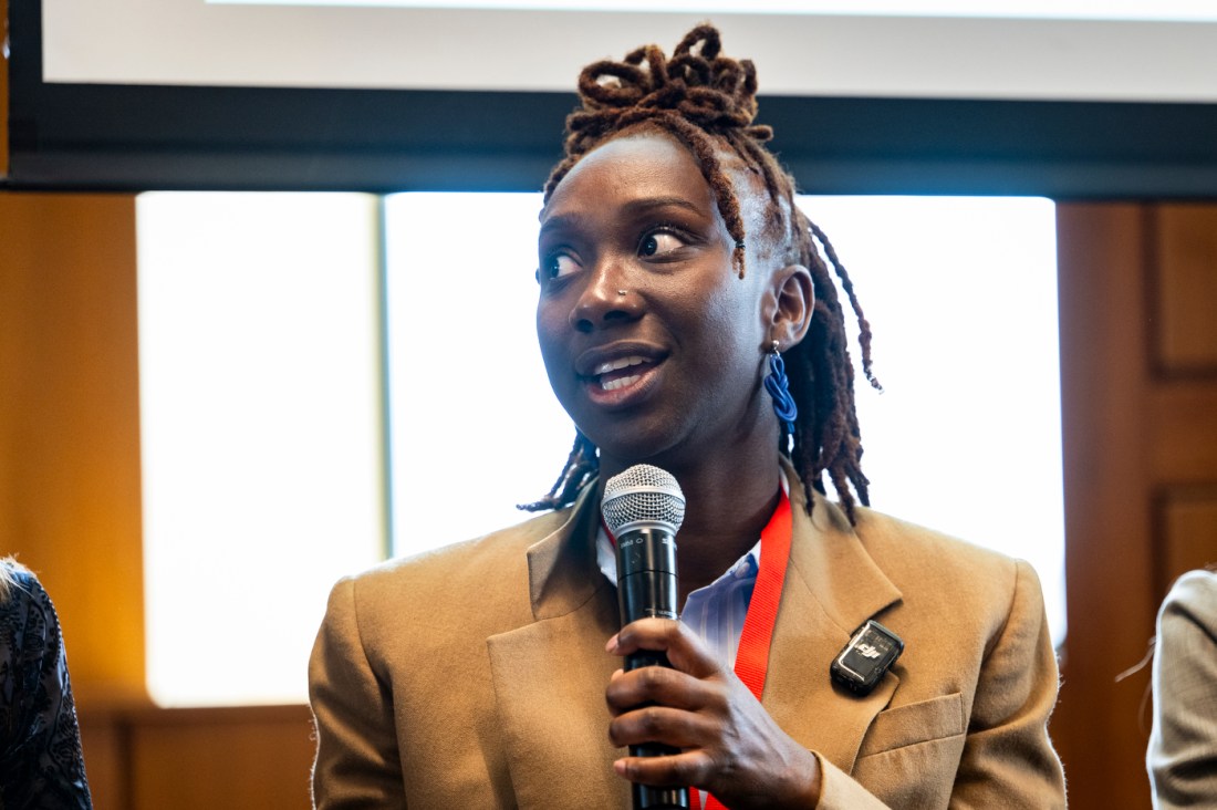 Gabby Aidam speaking into a microphone.