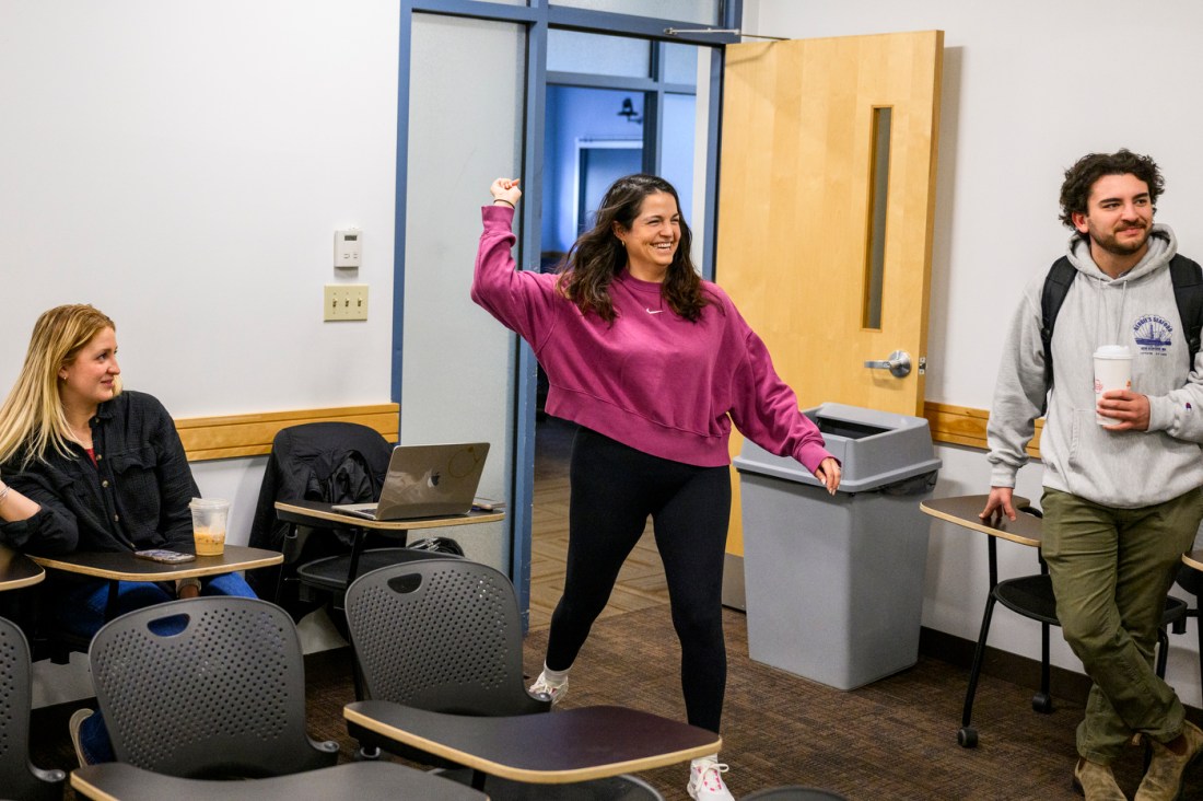 A student standing as if they're about to throw an object over their shoulder.