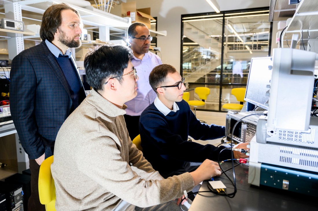 Cristian Cassella and Marvin Onabajo and Minghan Liu and Nicolas Casilli all gathered around a computer screen.
