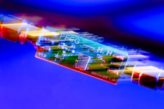 A quantum computing chip on a blue background.