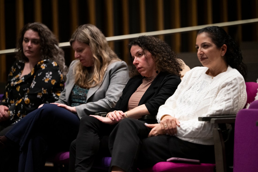 Audience members listen during a university speaking event.